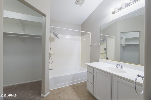 41388 W Hopper Dr, Maricopa, AZ 85138 - full bath featuring shower / bath combination, a walk in closet, vanity, tile patterned floors, and baseboards