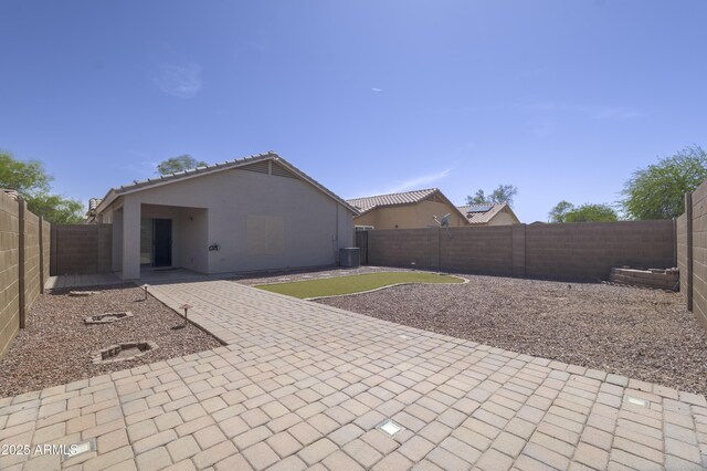 41388 W Hopper Dr, Maricopa, AZ 85138 - back of property featuring a patio, a fenced backyard, stucco siding, and central AC unit