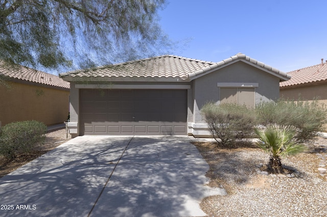 41388 W Hopper Dr, Maricopa, AZ 85138 - view of front of home featuring concrete driveway, a garage, stucco siding, and a tiled roof