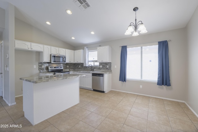 41388 W Hopper Dr, Maricopa, AZ 85138 - kitchen with stainless steel appliances, tasteful backsplash, white cabinetry, a chandelier, and vaulted ceiling
