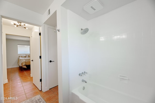 bathroom with shower / tub combination, tile patterned floors, and an inviting chandelier