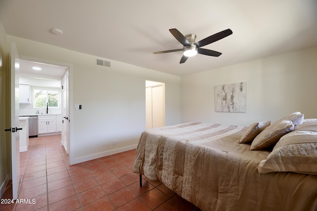 tiled bedroom featuring ceiling fan and sink