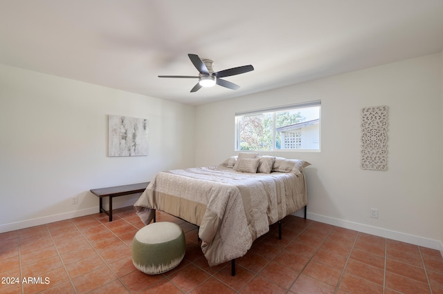 tiled bedroom featuring ceiling fan