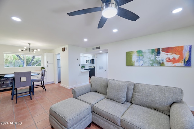 living room with light tile patterned floors and ceiling fan with notable chandelier