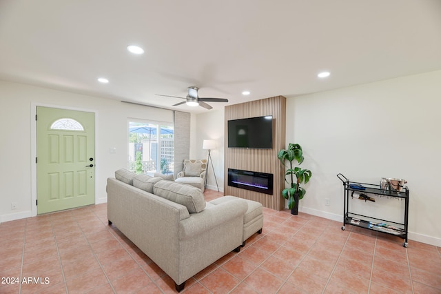 living room featuring ceiling fan, light tile patterned flooring, and a fireplace