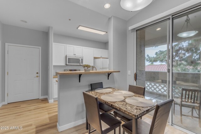 2929 W Yorkshire Dr Unit 2013, Phoenix, AZ 85027 - dining space featuring light wood-style floors and baseboards