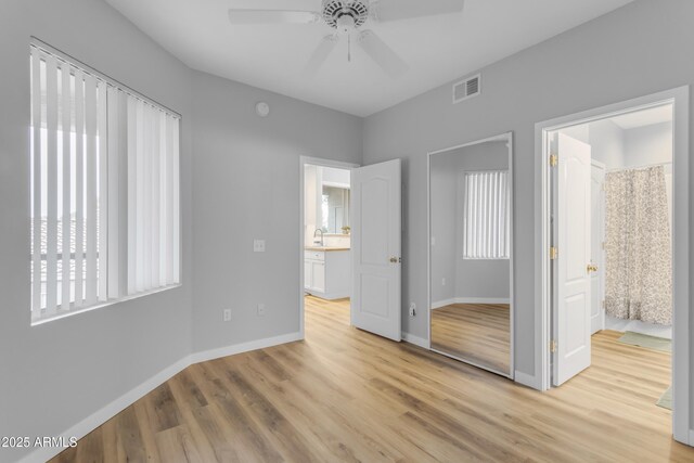 2929 W Yorkshire Dr Unit 2013, Phoenix, AZ 85027 - unfurnished bedroom featuring baseboards, visible vents, a ceiling fan, light wood-style floors, and a sink