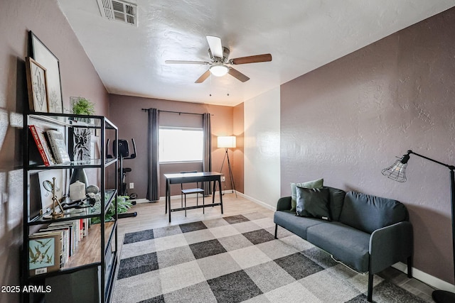 living area featuring ceiling fan