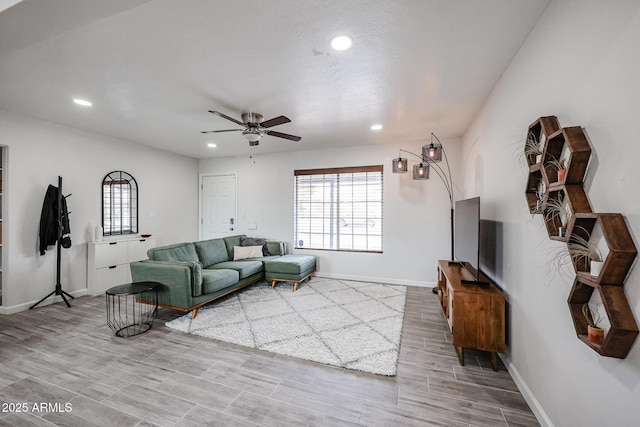 living room featuring a wealth of natural light and ceiling fan