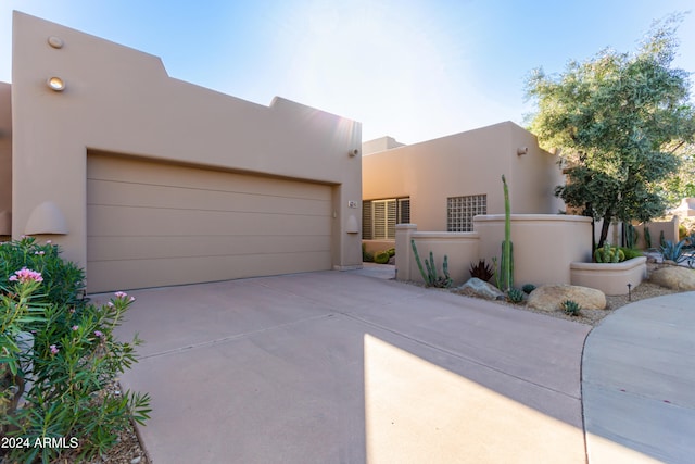 pueblo-style house with a garage