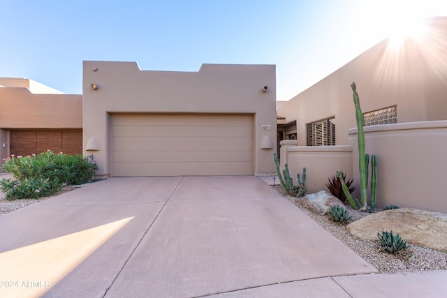 pueblo-style home with a garage