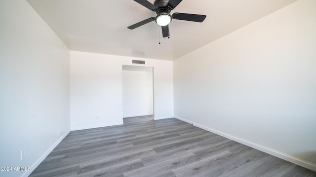 unfurnished room with ceiling fan and wood-type flooring