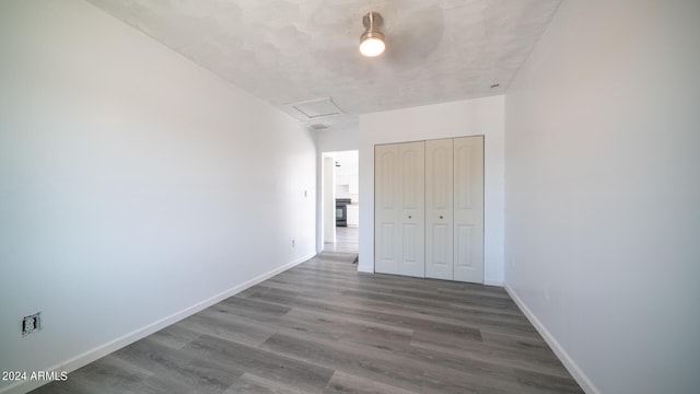 unfurnished bedroom with wood-type flooring and a closet