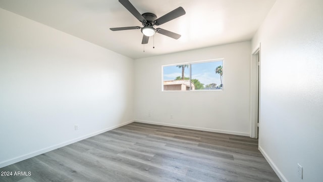 spare room with light hardwood / wood-style flooring and ceiling fan