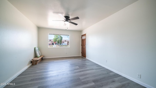 empty room featuring ceiling fan and dark hardwood / wood-style flooring