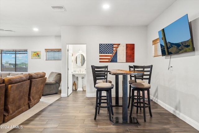 dining room featuring sink and dark hardwood / wood-style flooring