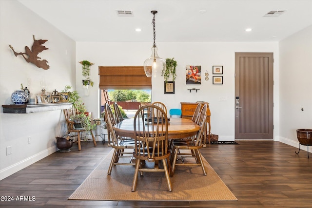 dining space with dark hardwood / wood-style flooring