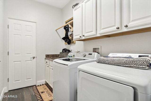 laundry room featuring separate washer and dryer, dark hardwood / wood-style floors, and cabinets