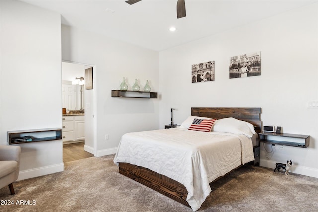 bedroom with hardwood / wood-style floors, ceiling fan, and ensuite bathroom