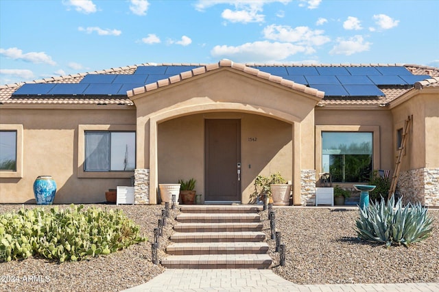 mediterranean / spanish home featuring solar panels