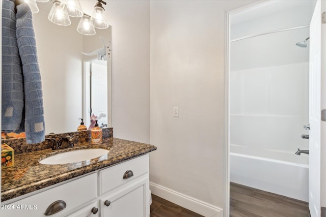 bathroom featuring shower / tub combination, vanity, and hardwood / wood-style flooring