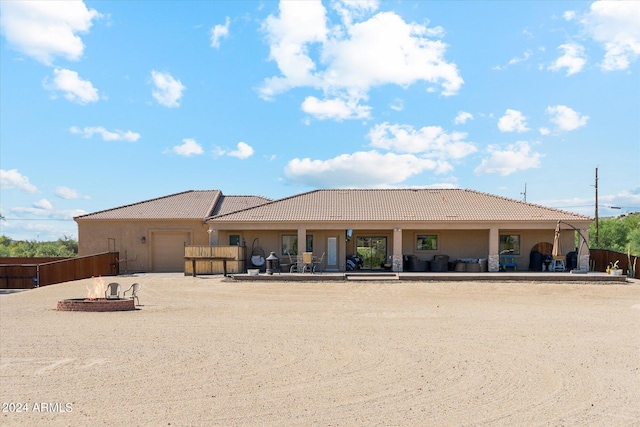 back of property featuring an outdoor fire pit