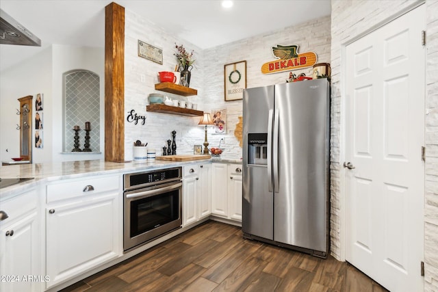 kitchen featuring light stone counters, dark wood-type flooring, stainless steel appliances, and white cabinets