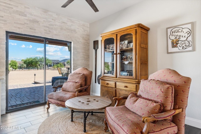 living area featuring ceiling fan and hardwood / wood-style floors