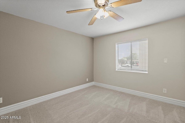 unfurnished room featuring baseboards, a ceiling fan, and light carpet