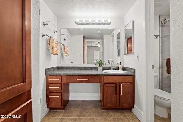 full bath with vanity, toilet, ceiling fan, tile patterned floors, and a stall shower