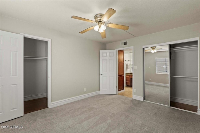 unfurnished bedroom featuring visible vents, baseboards, carpet floors, and ceiling fan