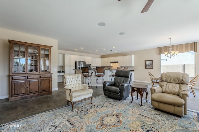 living room with ceiling fan with notable chandelier