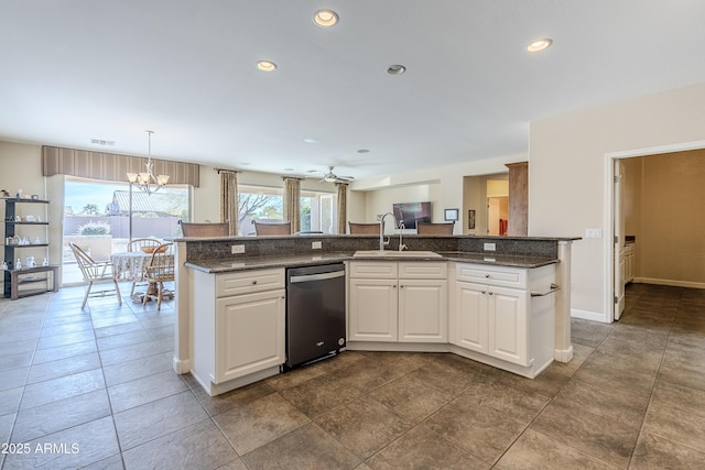 kitchen featuring sink, dishwasher, hanging light fixtures, plenty of natural light, and white cabinets