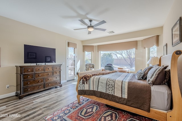 bedroom featuring access to exterior, ceiling fan, and light hardwood / wood-style flooring