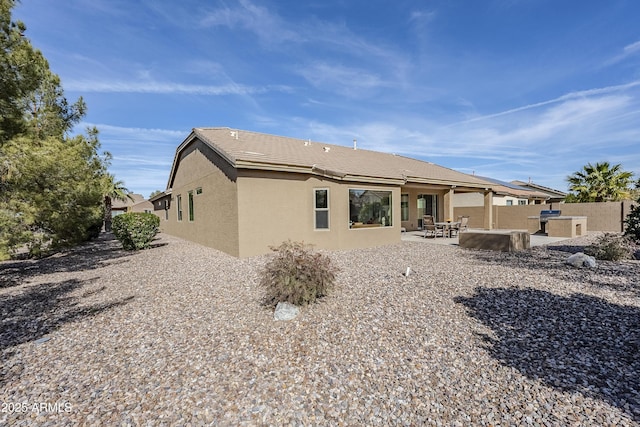 back of property featuring a patio area