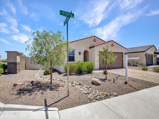 15817 S 177th Dr, Goodyear, AZ 85338 - mediterranean / spanish house featuring stucco siding, a garage, decorative driveway, and a tiled roof