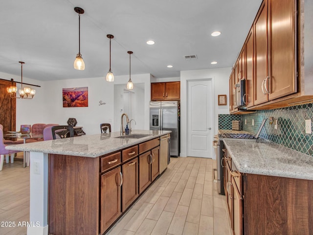 15817 S 177th Dr, Goodyear, AZ 85338 - kitchen with a sink, appliances with stainless steel finishes, light wood-style floors, backsplash, and recessed lighting