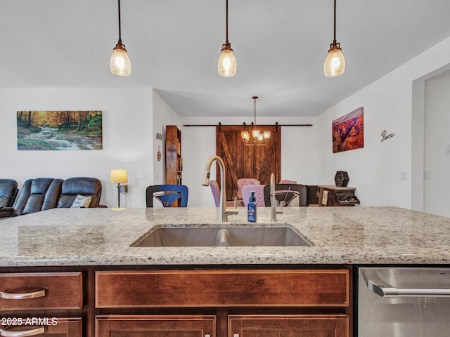 15817 S 177th Dr, Goodyear, AZ 85338 - kitchen with a sink, dishwasher, open floor plan, light stone counters, and pendant lighting