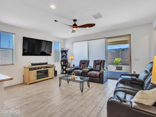 15817 S 177th Dr, Goodyear, AZ 85338 - living room with healthy amount of natural light, light wood-style flooring, ceiling fan, baseboards, and recessed lighting
