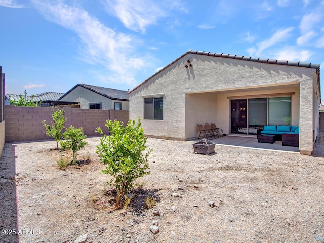 15817 S 177th Dr, Goodyear, AZ 85338 - back of property featuring stucco siding, an outdoor living space with a fire pit, a patio, and a fenced backyard