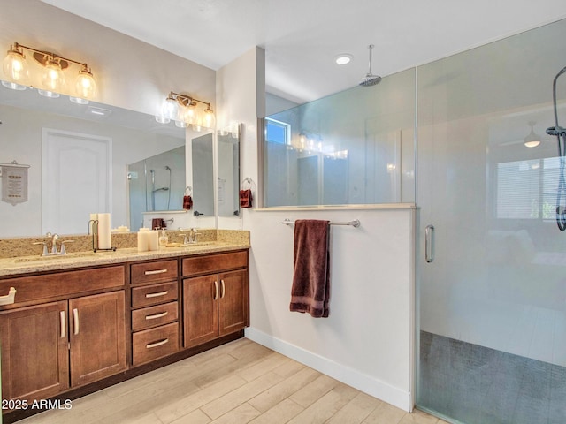 15817 S 177th Dr, Goodyear, AZ 85338 - full bathroom featuring a shower stall, double vanity, wood finished floors, and baseboards