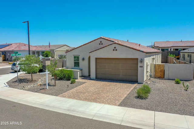 15817 S 177th Dr, Goodyear, AZ 85338 - view of front of home featuring stucco siding, a garage, driveway, a tiled roof, and a gate