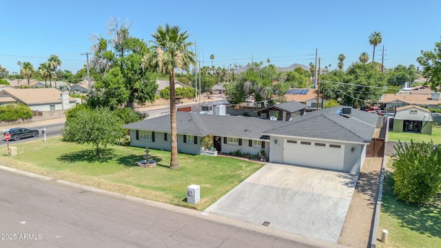 1208 E Tuckey Ln, Phoenix, AZ 85014 - single story home with an attached garage, concrete driveway, a front yard, and a residential view