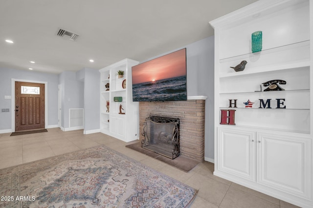 1208 E Tuckey Ln, Phoenix, AZ 85014 - living room featuring light tile patterned floors, a brick fireplace, built in features, and recessed lighting