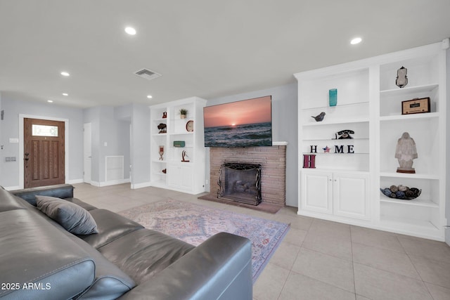 1208 E Tuckey Ln, Phoenix, AZ 85014 - living room with light tile patterned floors, built in features, recessed lighting, and a fireplace with raised hearth