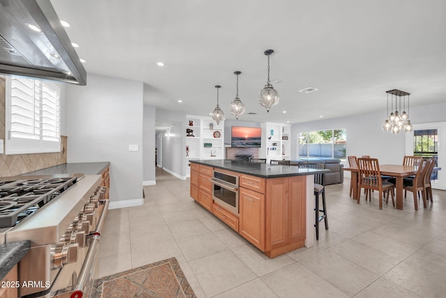 1208 E Tuckey Ln, Phoenix, AZ 85014 - kitchen featuring exhaust hood, high end range, dark countertops, recessed lighting, and a chandelier