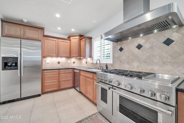 1208 E Tuckey Ln, Phoenix, AZ 85014 - kitchen featuring appliances with stainless steel finishes, wall chimney range hood, tasteful backsplash, recessed lighting, and light tile patterned flooring