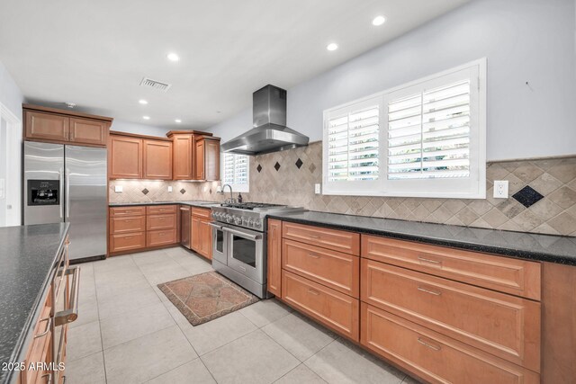 1208 E Tuckey Ln, Phoenix, AZ 85014 - kitchen with appliances with stainless steel finishes, island exhaust hood, decorative backsplash, recessed lighting, and brown cabinetry