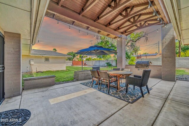 1208 E Tuckey Ln, Phoenix, AZ 85014 - patio terrace at dusk with a patio, an outdoor kitchen, a fenced backyard, and outdoor dining space