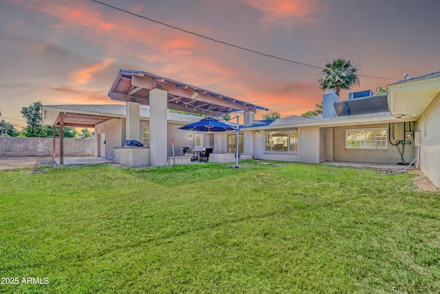 1208 E Tuckey Ln, Phoenix, AZ 85014 - back of property at dusk with a patio area and brick siding